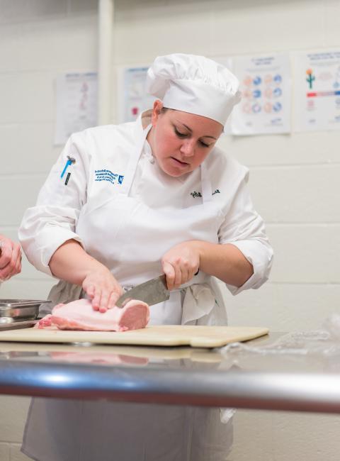 chef cutting meat